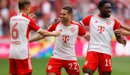 Bayern Munich's Portuguese defender #22 Raphael Guerreiro (C) celebrates scoring the opening goal with his teammates during the German first division Bundesliga football match between FC Bayern Munich and 1 FC Cologne in Munich, southern Germany on April 13, 2024. (Photo by Michaela STACHE / AFP)
