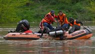 National Disaster Response Force (NDRF) conduct a rescue and search operation after a boat ferrying people across the Jhelum river capsized in Srinagar on April 16, 2024. (Photo by TAUSEEF MUSTAFA / AFP)