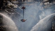 View taken from the tower of the Parliament as Danish firefighters and emergency personnel work on the structure during the final extinguishing operations one day after a fire ravaged the historic Boersen Stock Exchange and toppled its iconic spire in Copenhagen on April 17, 2024. Photo by Liselotte Sabroe / Ritzau Scanpix / AFP

