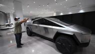 (FILES) Visitors view the Tesla Cybertruck at the recently reopened Petersen Automotive Museum in Los Angeles, California, July 1, 2020. (Photo by Robyn Beck / AFP)
