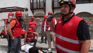 Emergency staff treat a volunteer roleplaying as an injured victim as they take part in the earthquake drill 