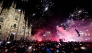 Inter Milan's supporters celebrate by the Duomo in central Milan after they won the 2024 Scudetto championship title on April 22, 2024, following the Italian Serie A football match between AC Milan and Inter Milan at the San Siro Stadium in Milan. (Photo by Piero CRUCIATTI / AFP)
