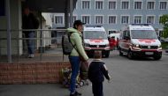 Relatives evacuate their children from childrens' hospital in Kyiv on April 26, 2024. Officials in Ukraine's capital Kyiv announced the evacuation of two hospitals on April 26, 2024, fearing they could be targeted by Russian strikes. (Photo by Sergei CHUZAVKOV / AFP)
