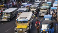 In this photo taken on April 5, 2024, jeepneys commute along a street in Manila. (Photo by Ted ALJIBE / AFP)
