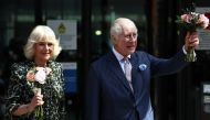 Britain's King Charles III and Britain's Queen Camilla wave to the crowds after a visit to the University College Hospital Macmillan Cancer Centre in London on April 30, 2024. (Photo by Henry Nicholls / AFP)
 