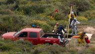 A rescue worker prepares to descend into a waterhole where human remains were found near La Bocana Beach, Santo Tomas delegation, in Ensenada, Baja California State, Mexico, on May 3, 2024. (Photo by Guillermo Arias / AFP)
