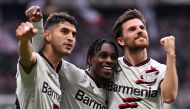 Bayer Leverkusen's Dutch defender #30 Jeremie Frimpong (C), Bayer Leverkusen's German midfielder #07 Jonas Hofmann (R) and Bayer Leverkusen's Argentine midfielder #25 Exequiel Palacios celebrate scoring a goal during the German first division Bundesliga football match between Eintracht Frankfurt and Bayer 04 Leverkusen in Frankfurt am Main, western Germany on May 5, 2024. (Photo by Kirill KUDRYAVTSEV / AFP) 
