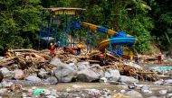Rescue personnel search for the missing by a riverside amusement park following flash flooding along the Batang Anai River in Padang Pariaman, West Sumatra, on May 15, 2024. (Photo by REZAN SOLEH / AFP)

