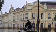 A man navigates a boat through a flooded street in front of the public market in downtown Porto Alegre, Rio Grande do Sul State, Brazil, on May 19, 2024. Photo by Nelson ALMEIDA / AFP