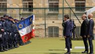 France's Prime Minister Gabriel Attal and France's Justice Minister Eric Dupond-Moretti face the prison guard units presenting the flag of France as they attend at the former prison in Caen, northwestern France, 22 May 2024. Photo by Teresa Suarez / POOL / AFP.