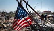 An American flag is see as residents go through the damage after a tornado tore through town yesterday afternoon on May 22, 2024 in Greenfield, Iowa. Photo by SCOTT OLSON / GETTY IMAGES NORTH AMERICA / Getty Images via AFP.
