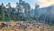 People gather at the site of a landslide in Maip Mulitaka in Papua New Guinea's Enga Province on May 24, 2024. (Photo by AFP)