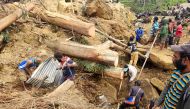 This handout photo taken and received on May 27, 2024 from the International Organization for Migration shows locals digging at the site of a landslide at Mulitaka village in the region of Maip Mulitaka, in Enga Province, Papua New Guinea. (Photo by Mohamud Omer / International Organization for Migration / AFP) 