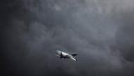 A Virgin Australia Airlines Boeing 737 plane flies as a storm approaches at Sydney International Airport on June 7, 2024. Photo by DAVID GRAY / AFP.