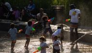 Children play with water guns at a splash pad at LeFrak Center at Lakeside at Prospect Park in Brooklyn, New York, as a heat wave hits the northeast US on June 20, 2024. (Photo by Yuki IWAMURA / AFP)
