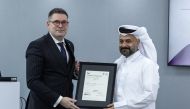 Yousuf Mohamed Al Jaida, Chief Executive Officer, QFC receiving the ISO certification from Ilias Karampoikis, IMETA Sales and Commercial Director, BSI.