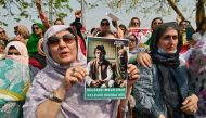 Pakistan's former prime minister Imran Khan's supporters protest outside the court in Islamabad on June 27, 2024. (Photo by Farooq Naeem / AFP)