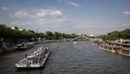 A touristic boat navigates on the River Seine in Paris on June 26, 2024. Photo by OLYMPIA DE MAISMONT / AFP.
