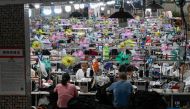 This photo taken on June 11, 2024 shows workers producing garments at a textile factory that supplies clothes to fast fashion e-commerce company Shein in Guangzhou in southern China's Guangdong province. Photo by Jade GAO / AFP.