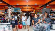 People shop groceries at a supermarket in Scarborough, Trinidad and Tobago, as they prepare for the arrival of Hurricane Beryl on June 30, 2024. (Photo by Clement George Williams / AFP)