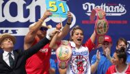 Miki Sudo celebrates after winning the women's title during the 2024 Nathan's Famous Fourth of July hot dog eating competition at Coney Island in the Brooklyn borough of New York on July 4, 2024. Sudo won after consuming a record-breaking 51 hotdogs. (Photo by Leonardo Munoz / AFP)
