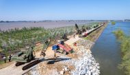 A drone photo taken on July 6, 2024 shows Rescuers working to block a dike breach in Tuanzhou Township, Huarong County under Yueyang City, central China's Hunan Province. (Xinhua/Chen Sihan)
