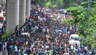 Students block roads as they protest to demand a merit-based system for civil service jobs in Dhaka on July 10, 2024. (Photo by Munir Uz Zaman / AFP)
 