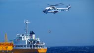 Handout from Japan Coast Guard Yokosuka Office released on July 10, 2024 shows a coast guard helicopter being used to lift the woman from a tanker where she had been receiving medical attention after being found. (Photo by Handout / Japan Coast Guard Yokosuka Office / AFP) 