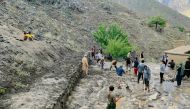 Afghan residents shovel mud following flash floods after heavy rainfall at Pesgaran village in Dara district, Panjshir province on July 15, 2024. (Photo by AFP)

