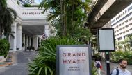 People walk past the main entrance of the Grand Hyatt Erawan hotel in Bangkok on July 17, 2024. (Photo by Chanakarn Laosarakham / AFP)