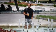 A man cools off in a fountain in the center of Sofia on July 18, 2024, as Bulgaria experiences a heatwave with temperatures reaching 42 degrees Celsius across the country. (Photo by Nikolay Doychinov / AFP)