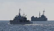 This file photo taken on April 23, 2023 shows Philippine coast guard vessel BRP Malapascua (L) patrolling near the grounded navy ship BRP Sierra Madre where Philippine marines are stationed to assert Manila's territorial claims at Second Thomas Shoal in the Spratly Islands in the disputed South China Sea. Photo by Ted ALJIBE / AFP