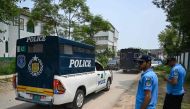 Policemen make way for prison van afer a security raid at the Pakistan Tehreek-e-Insaf (PTI) party's headquarters in Islamabad on July 22, 2024. (Photo by Aamir QURESHI / AFP)
