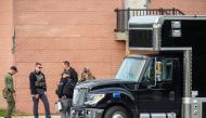 Law enforcement officers gather outside Lewiston High School, Maine on October 26, 2023. (Photo by Joseph Prezioso / AFP)

