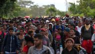 Hundreds of migrants, mostly from Central America, set out in a US-bound caravan to escape poverty and violence, on the outskirts of Tapachula, State of Chiapas, Mexico, on July 23, 2024. (Photo by ISAAC GUZMAN / AFP)
