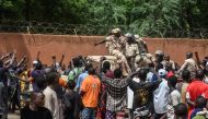 (FILES) Protesters cheer Nigerien troops as they gather in front of the French Embassy in Niamey during a demonstration that followed a rally in support of Niger's junta in Niamey on July 30, 2023. (Photo by AFP)

