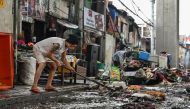 Residents clean their houses in the aftermath of Typhoon Gaemi in Manila on July 25, 2024. (Photo by Jam Sta Rosa / AFP)
