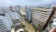 This photo taken and released by Taiwan's Central News Agency (CNA) on July 25, 2024 shows a general view of a flooded street caused by heavy rains brought by Typhoon Gaemi in Kaohsiung. (Photo by CNA / AFP) 