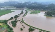 This handout photo taken on July 25, 2024 and released courtesy of the Akita Prefecture River Sabo Division to AFP on July 26, shows flooding along the Ishizawa river, whose embankment collapsed due to heavy rains, in Yurihonjo, Akita prefecture. Photo by Handout / Akita Prefecture River Sabo Division / AFP