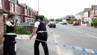 Police officers stand guard behind a cordon on Hart Street in Southport, northwest England, on July 29, 2024, following a knife attack. (Photo by Darren Staples / AFP)
