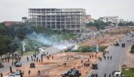 A cloud of tear gas fired by Nigerian security forces lingers during the End Bad Governance protest in Abuja on August 2, 2024. (Photo by Kola Sulaimon / AFP)