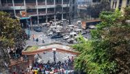 People gather to see burnt Jatrabari police station as anti-government protestors set fire in Dhaka on August 6, 2024, after former prime minister Sheikh Hasina fled the country. (Photo by Abdul Goni / AFP)
