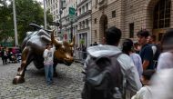 People take pictures at the Wall Street Bull on August 08, 2024 in New York City. (Photo by SPENCER PLATT / GETTY IMAGES NORTH AMERICA / Getty Images via AFP)
