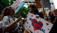 People hold anti-racist placards as they take part in a 