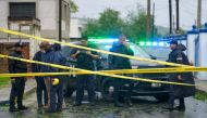 Police block a flooded road in Fajardo, Puerto Rico, as Tropical Storm Ernesto passes through the area on August 14, 2024. (Photo by Jaydee Lee SERRANO / AFP)
