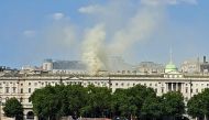 Viewed from Waterloo Bridge, smoke is seen rising into the sky from a fire located in the roof of Somerset House beside the River Thames in London on August 17, 2024. Photo by James RYBACKI / AFP