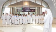 A Qatar Rail official briefs students at a metro station. 