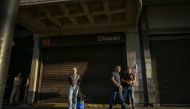 People walk in front of an entrance to a metro station in Caracas on August 30, 2024. Photo by JUAN BARRETO / AFP.