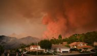 Smoke from the Airport Fire billows above homes in Rancho Santa Margarita, California, on September 9, 2024. Photo by Patrick T. Fallon / AFP.