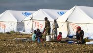Displaced Sudanese who have returned from Ethiopia gather in a camp run by the United Nations Refugee Agency (UNHCR) in Sudan's border town of Gallabat in the eastern state of Gadaref on September 11, 2024.  (Photo by Ebrahim Hamid / AFP)
